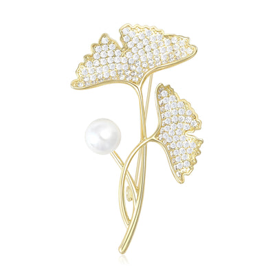 Front view of gold tone ginkgo leaves on curling stems with two pearl accents