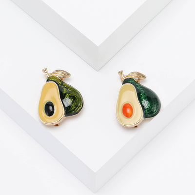 Front view of the avocado brooch showing a green avocado half with cream flesh and a colored stone pit