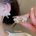 Pearl Bow And Floral Stud Earrings With Polished Metal Tone Details view 2