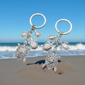 Two Silver Tone Turtle Family Keychain Designs with Metal Hardware view 1