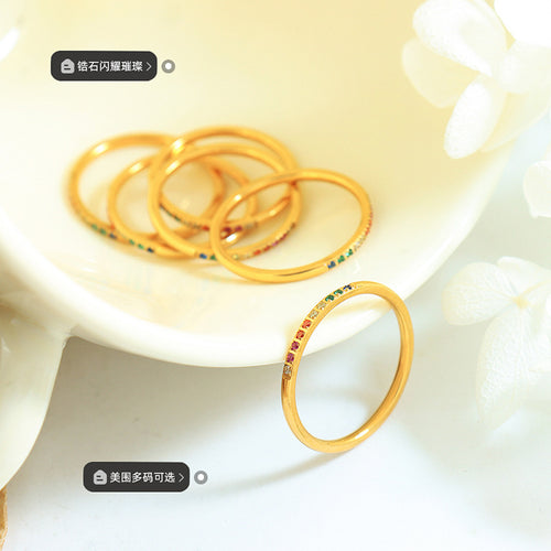 Gold thin zircon rings piled on cream dish size stone tags