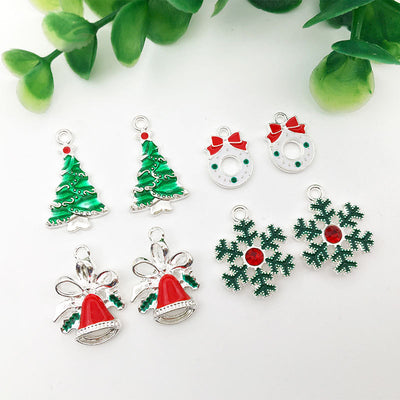 Colorful christmas tree and snowflake charms arranged on a light background