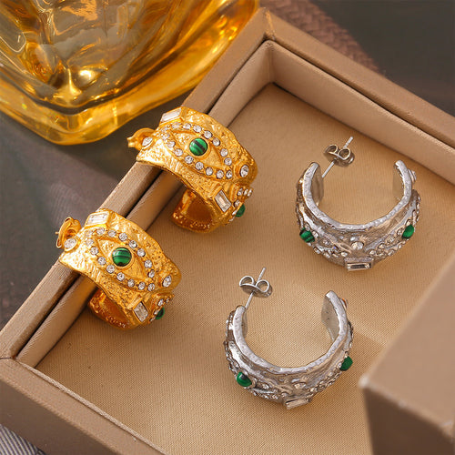 Gold and steel evil eye thick hoop earrings in jewelry tray