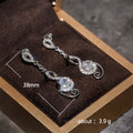 Silver Tone Swirl Drop Earrings with Clear Teardrop Stones view 5