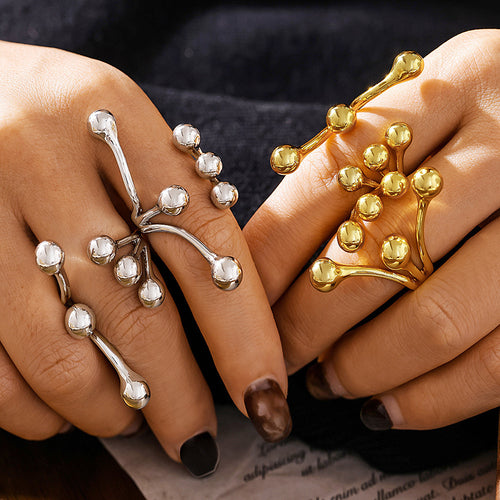 Gold and steel branch sphere rings on both hands