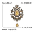 Teardrop Glass Brooch With Ornate Antique Tone Crystal Frame view 7