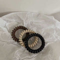 Black Matte Telephone Cord Spiral Coil Hair Tie With Thick Profile view 1