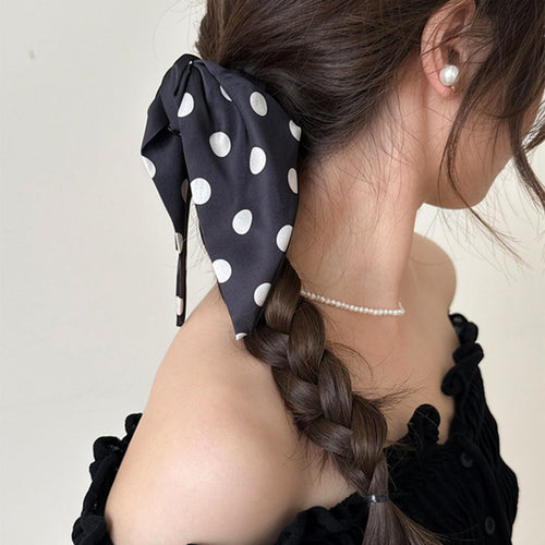Black white polka fabric bow claw clip worn with braid