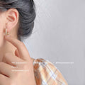 Polished Oval Huggie Hoop Earrings Gold and Silver view 3