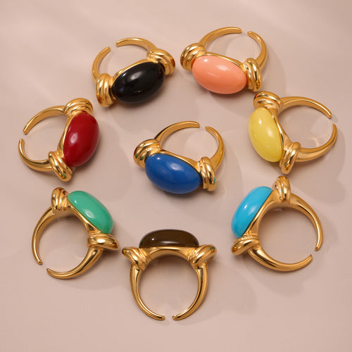 Group of gold oval resin open rings in assorted bright colors