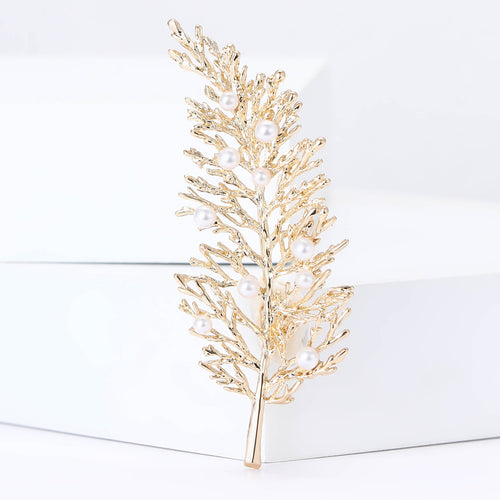 long fern leaf brooch displayed on a product backdrop
