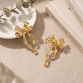 Gold Tone Sculptural Bow Ribbon Long Stud Earrings view 3