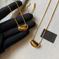Gold Tone Fine Chain Necklace With Brown Teardrop Pendant view 2