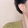 Mini Gold Daisy Stud Earrings With White Pearl Center view 2