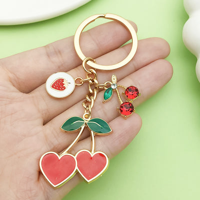 Image 1 showing a person holding two different colored charms.