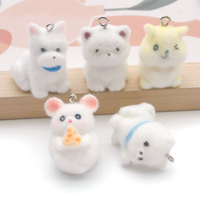 Multicolor rabbit charms arranged on a light background