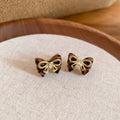 Gold Tone Bow Stud Earrings With Black Enamel Accents view 6