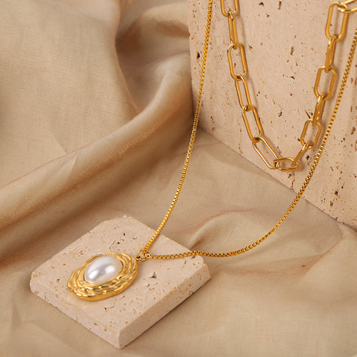 Gold twisted frame faux pearl pendant with paperclip chain on silk