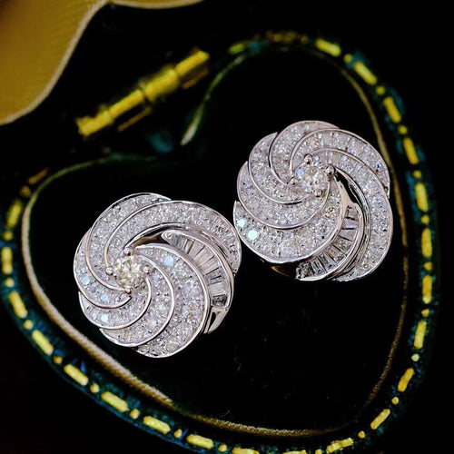Product view showing pave swirl round cluster stud earrings in polished silver tone