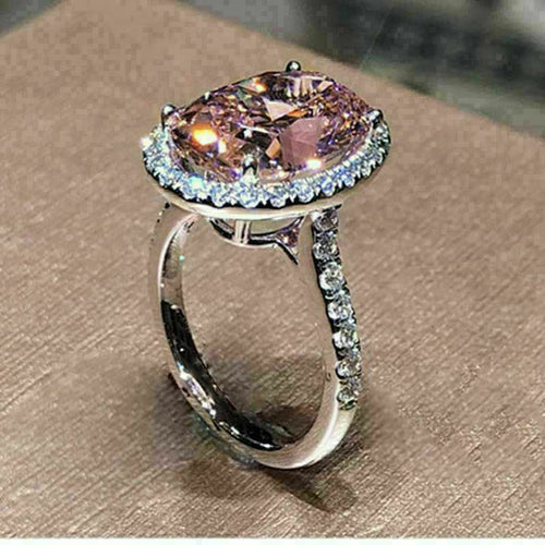 Product view showing silver-tone pink oval solitaire halo ring