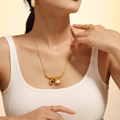 Gold arc bar dual stone necklace worn on model collarbone