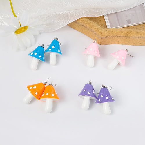 Orange purple pink and blue mushroom pairs laid out