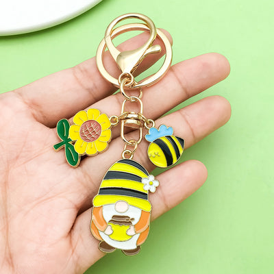 Image 1 showing a person holding a keychain with some flowers.
