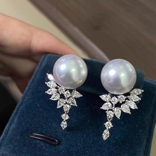 Pearl crystal spray studs displayed on blue velvet