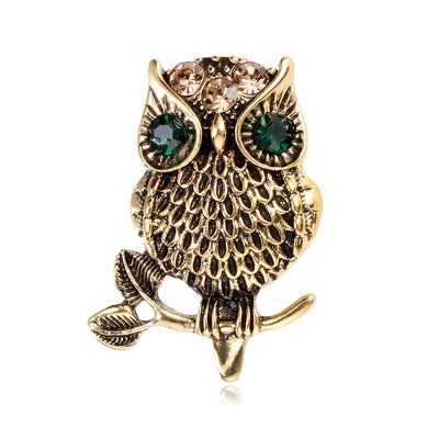 Front product view of the owl brooch pin in gold and black