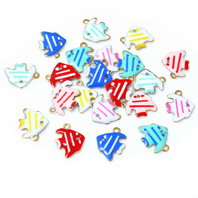 Overview of small striped fish charms with bright enamel bodies and gold-tone hanging loops arranged on a light backgrou