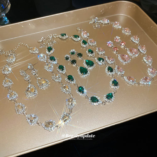 clear green pink and champagne teardrop crystal jewelry sets grouped together