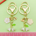 Bee and Honeycomb Charm Keychains Featuring White Blossom Across 10 Pictured Variations view 3
