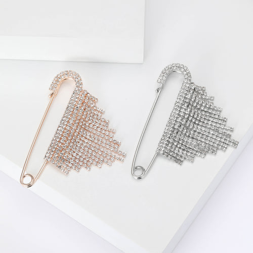Rose gold and silver rhinestone fringe safety pin brooches on white