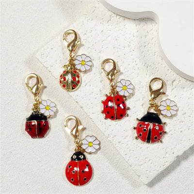Main product view of gold Tone Daisy and Ladybug Lobster-Clasp Charms in Five Designs