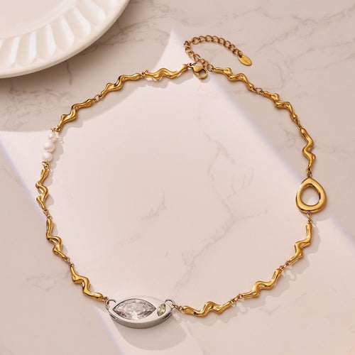 Neckline view of wavy toggle eye and pearl necklaces in main image 1.