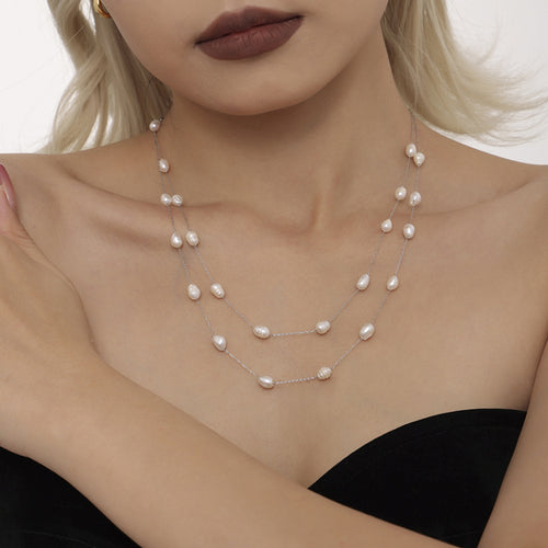 Model wearing silver steel double freshwater pearl station necklace