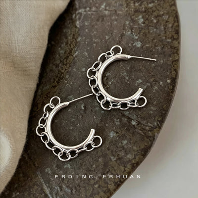 Silver thick C hoops with outer chain on display surface