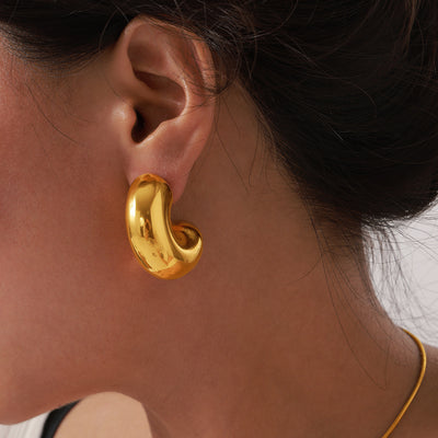 Gold C-shape chunky stud earring worn on ear side view