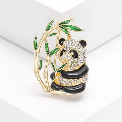 Front view of the crystal panda on green bamboo brooch decorative clothing pin on a white background