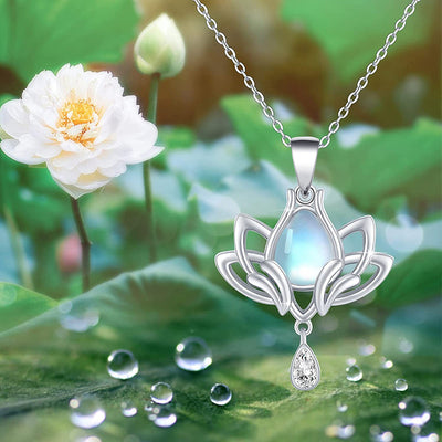 Silver lotus teardrop pendant necklace over green lotus leaf backdrop