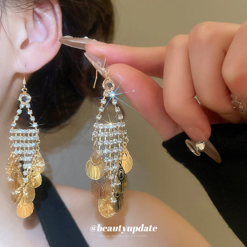 gold tone crystal chain and disc fringe hook earrings shown in an on-ear styling view