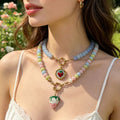 Round Bead Necklaces With Three Gold And Cream Strawberry Pendants view 3
