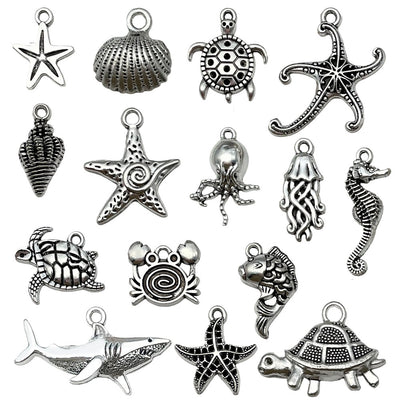 Metallic octopus and turtle charms arranged on a light background