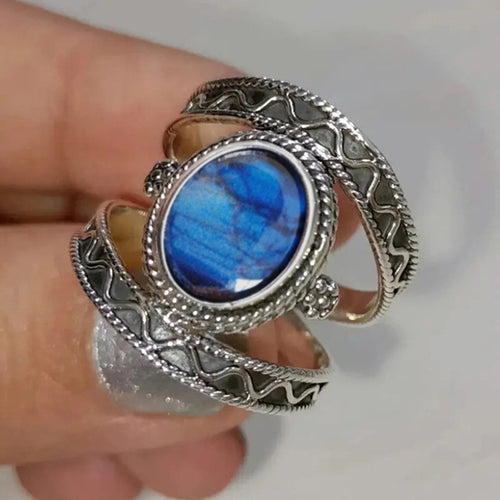 Duplicate antique silver blue oval wrap ring in hand