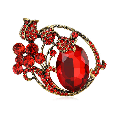 Angled display of curved floral brooch centered on a large faceted oval stone