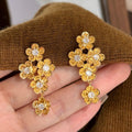 Gold Tone Crystal Flower Cluster Drop Earrings with Metal Tone Details view 1