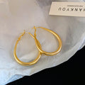 Slim Oval Statement Hoop Earrings in Gold and Silver Tones view 6