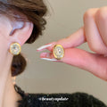 Gold Tone Brushed Oval Stud Earrings With Clear Crystal Centers view 2