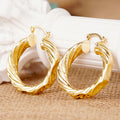 Gold Tone Wavy Concave Twisted Side Hoop Latch Earrings view 1