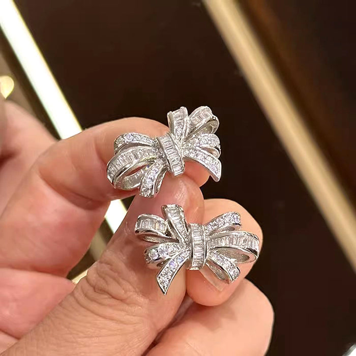 Silver Tone Bow Stud Earrings with Clear Baguette CZ
